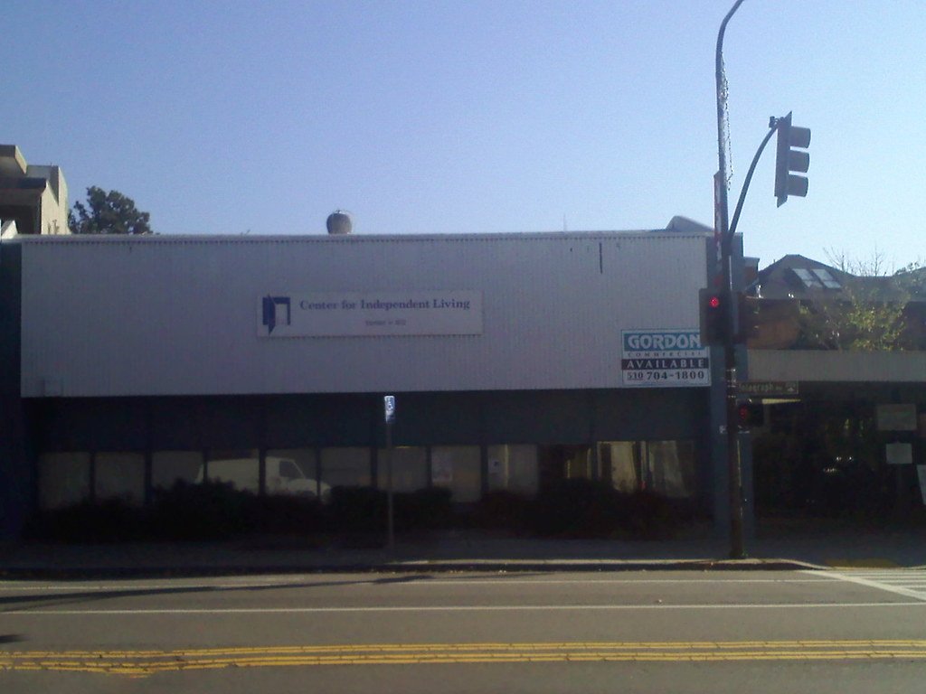 The original Center for Independent Living building on Telegraph Avenue in Berkeley, with the CIL sign and an open-door logo on the facade.